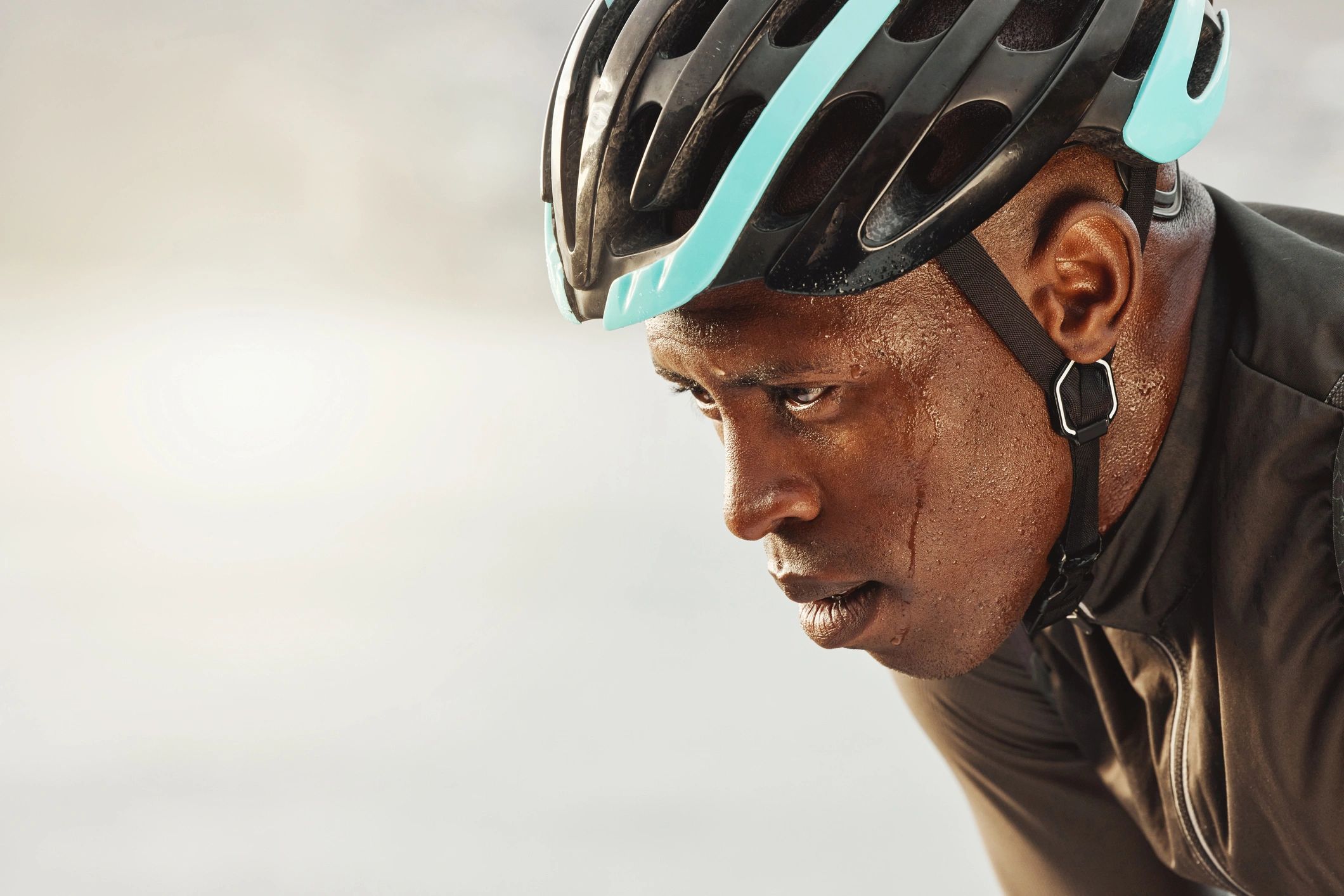 Close-up of a cyclist wearing a helmet, emphasizing protective gear