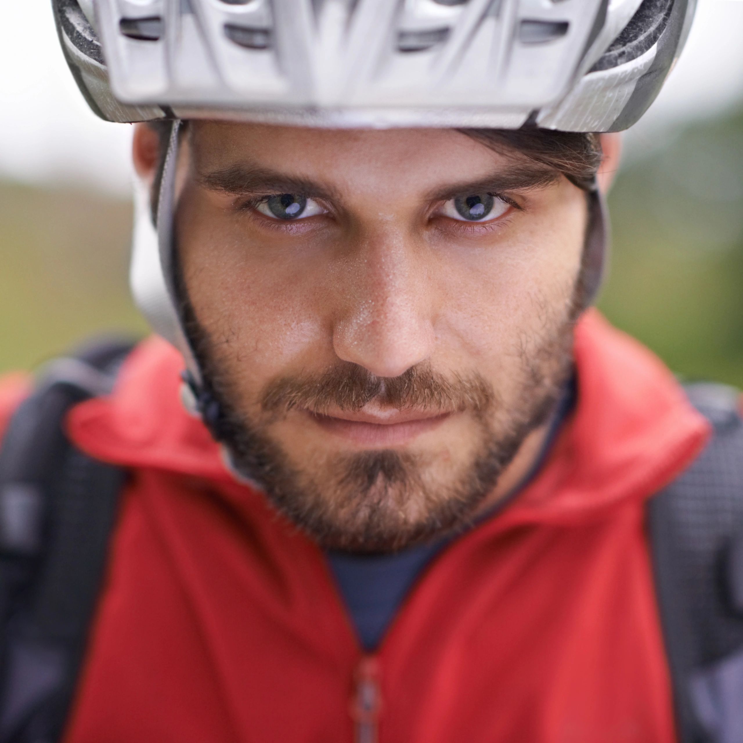 Close-up portrait of a cyclist wearing a helmet